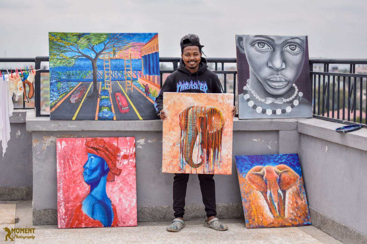 Artist presenting a collection of original paintings