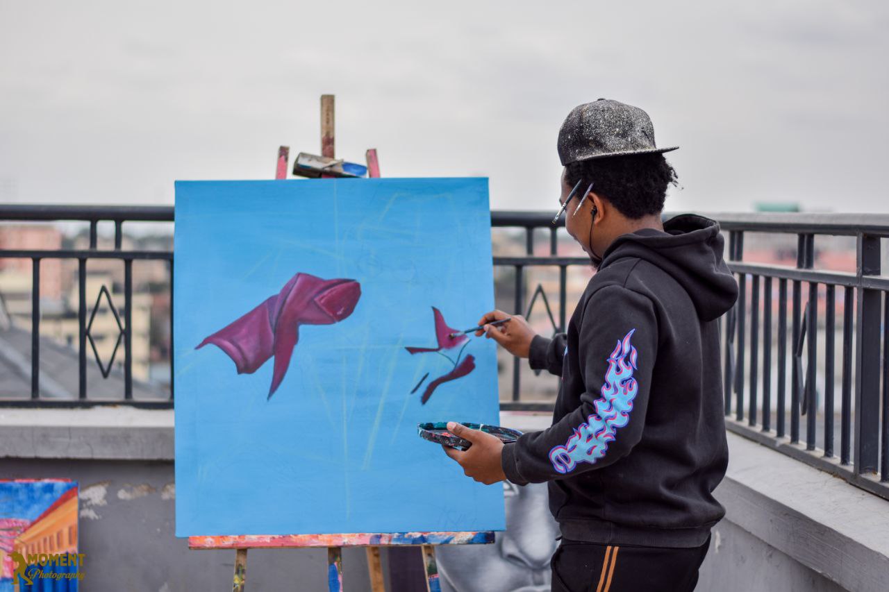 Artist painting an original canvas in the studio