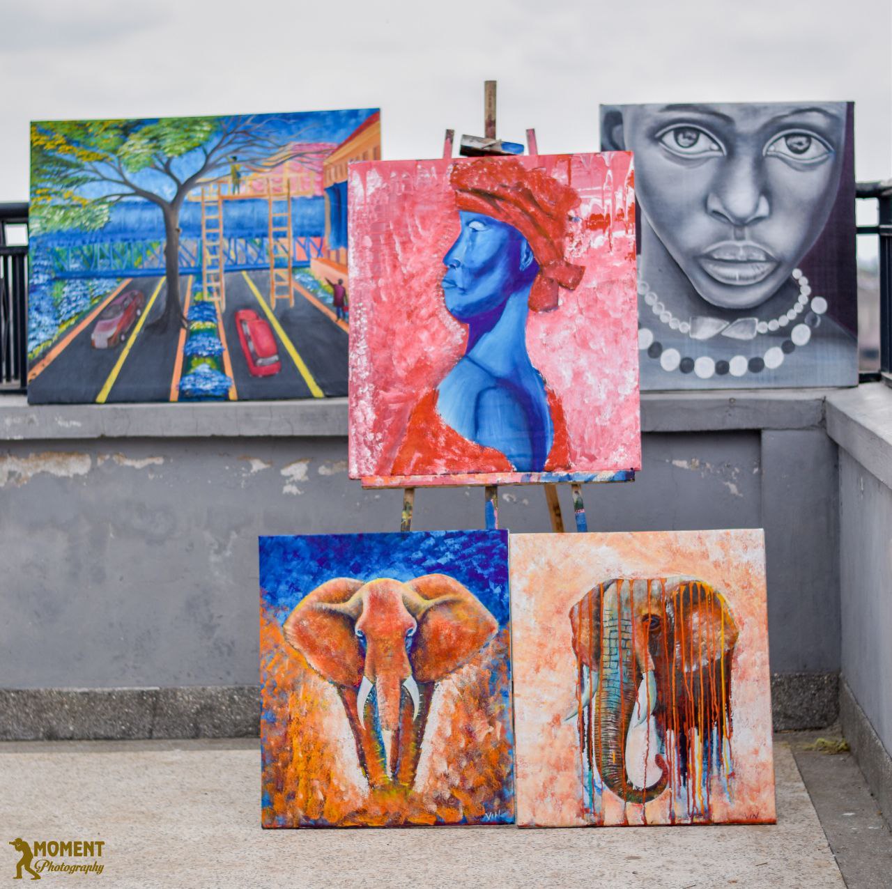 A curated display of five original paintings